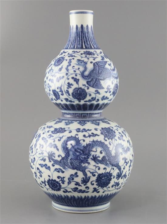 A Chinese blue and white dragon and phoenix double gourd vase , Qianlong mark but late 19th/early 20th century, H. 35.cm